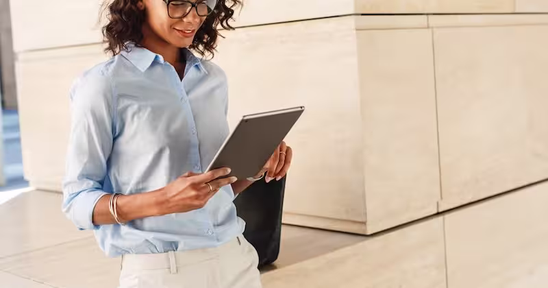 Hotel staff member conducting a brand standards audit on a tablet